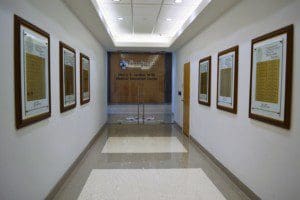 The view a hall with multiple frames on the wall