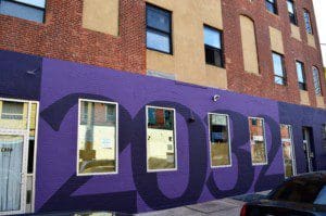 The view of a building with purple paint and number print