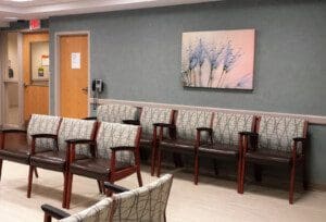 Art frame on the wall and chairs arranged