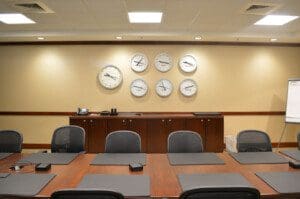 A picture of different time zone clocks on the wall