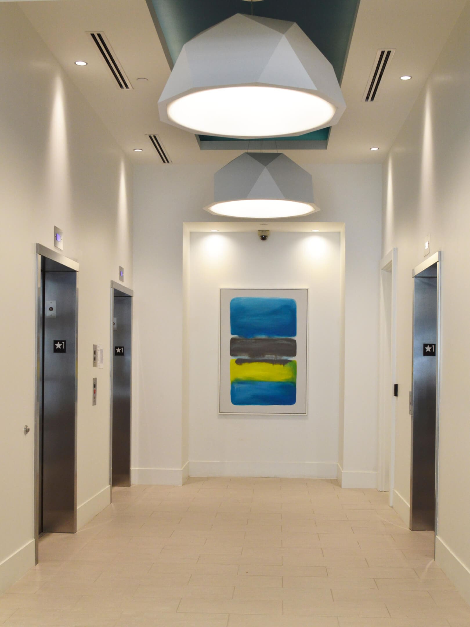 White ceiling lights with three elevators