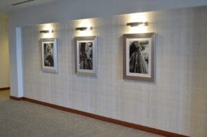 A picture of three frames on the wooden wall