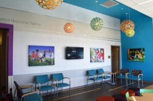 Television fixed on the wall and hanging lights