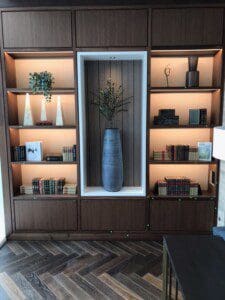 The close up view of a dark wood furniture with huge flower pot