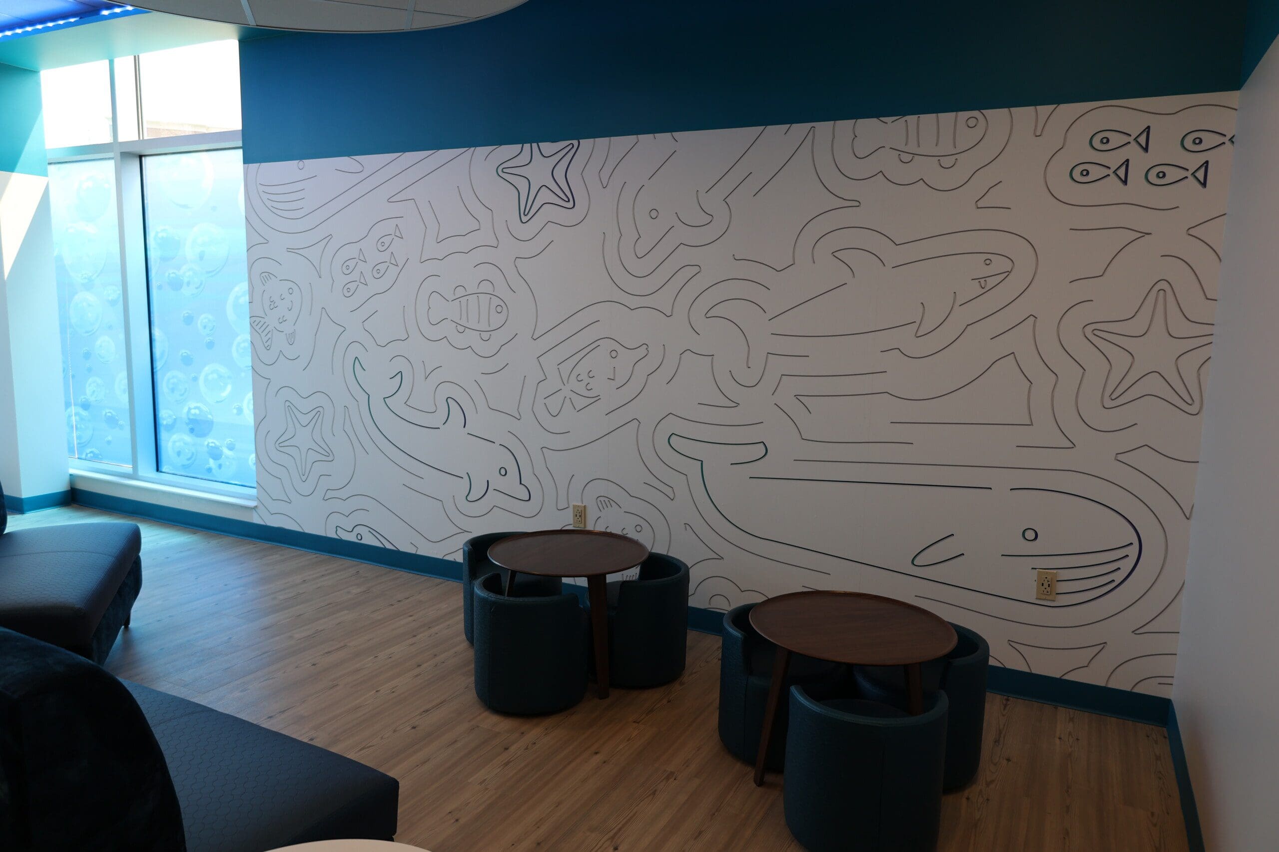 A statement wall with elaborate line art of water and fish